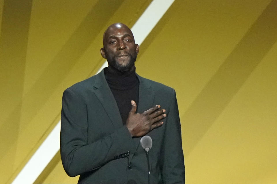 Kevin Garnett puts his hand on his heart during a speech during the 2020 Basketball Hall of Fame enshrinement ceremony, Saturday, May 15, 2021, in Uncasville, Conn. (AP Photo/Kathy Willens)