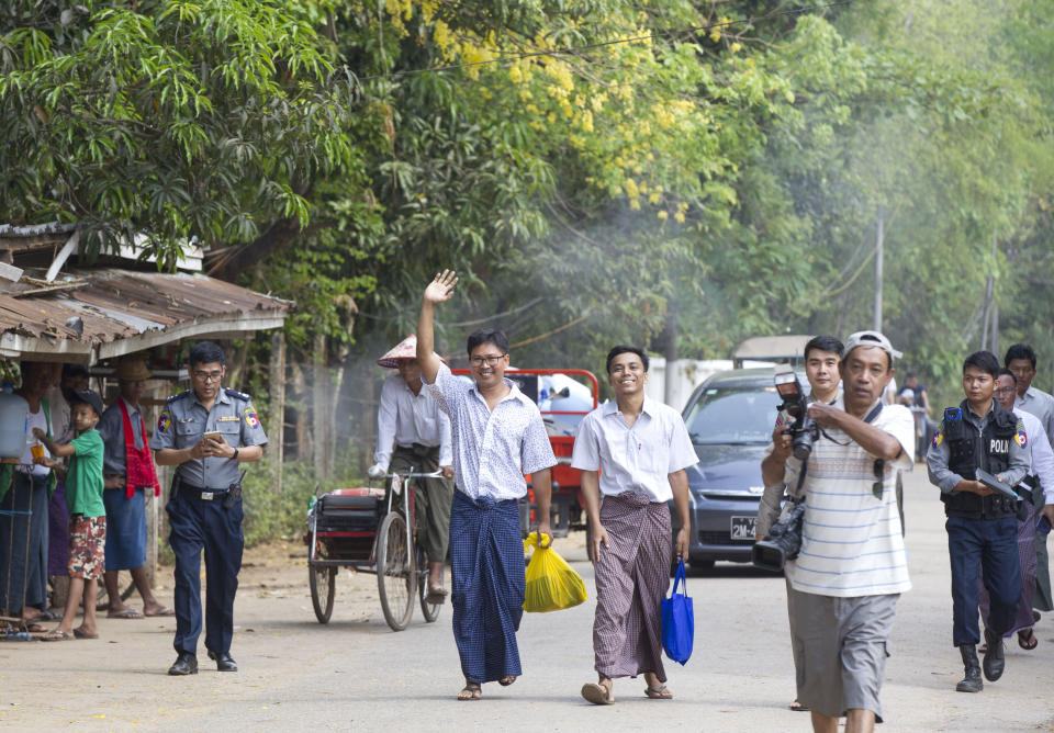 Reuters journalists Wa Lone, center left, and Kyaw She Oo, center right, walk out from Insein Prison after being released in Yangon, Myanmar Tuesday, May 7, 2019. The chief of the prison said two Reuters journalists who were imprisoned for breaking the country's Officials Secrets Act have been released. (AP Photo/Thein Zaw)