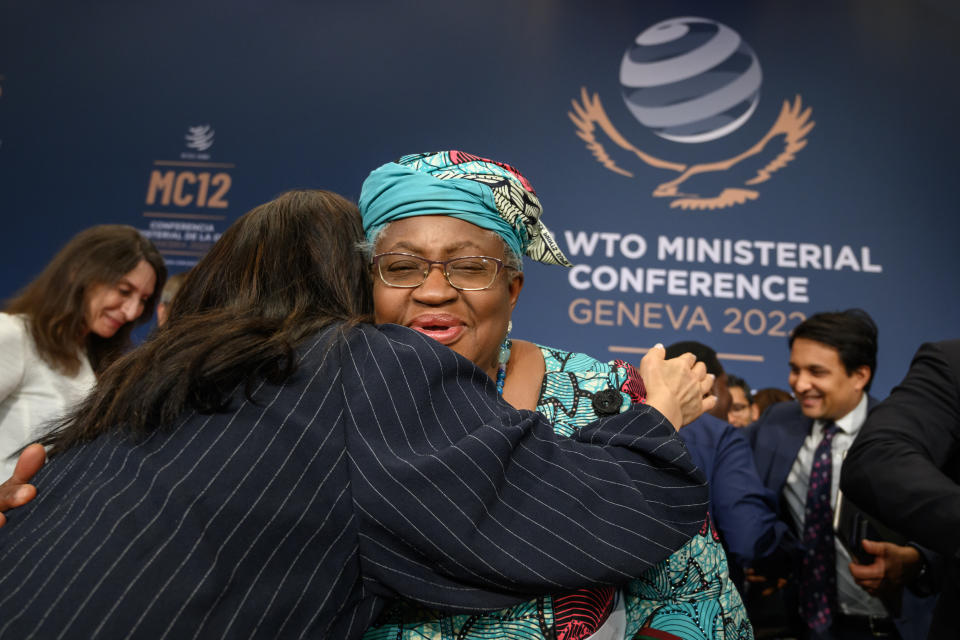 A delegate reacts with World Trade Organization Director-General Ngozi Okonjo-Iweala, centre, after a closing session of a World Trade Organization Ministerial Conference at the WTO headquarters in Geneva early Friday, June 17, 2022. (Fabrice Coffrini/Pool Photo/Keystone via AP)