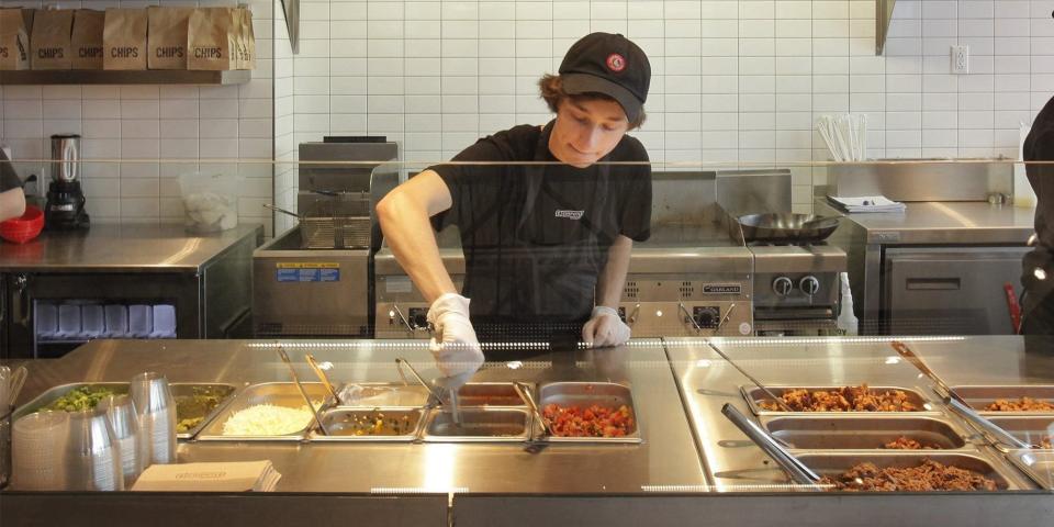 Chipotle worker at assembly line