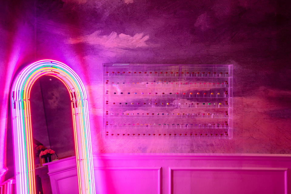 The Perspex display cabinet and neon rainbow mirror at the Hotlips by Solange store in London.