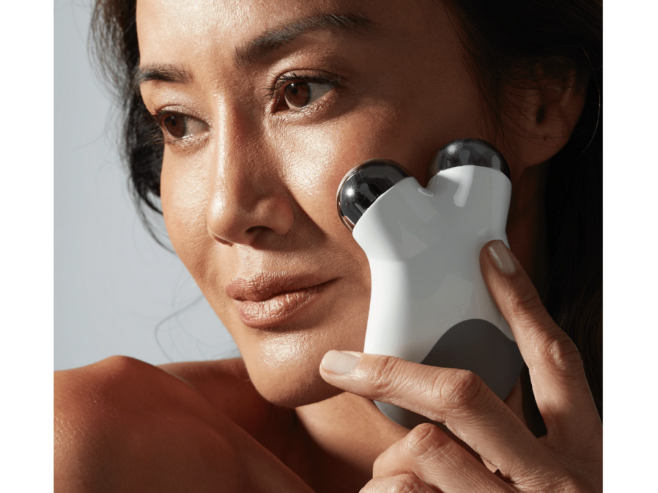 NuFace Mini used by a woman on her facial skin.