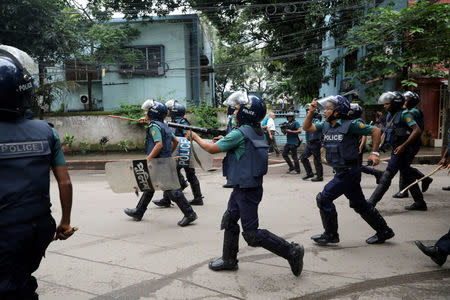 FILE PHOTO: Police fire tear gas shells during a protest over recent traffic accidents that killed a boy and a girl, in Dhaka, August 5, 2018. REUTERS/Mohammad Ponir Hossain