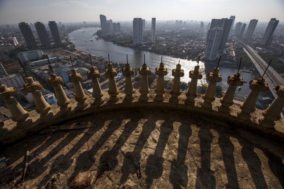 Central Bangkok and the Chao Phraya River are seen from an abandoned skyscraper in Bangkok. The abandoned building, known as Sathorn Unique, dubbed the 'ghost tower' was destined to become one of Bangkok's most luxurious residential addresses but construction was never completed as the Thai economy was hit during the 1997 Asian Financial Crisis. Now, many travellers visit and explore the 49-story skyscraper. (REUTERS/Athit Perawongmetha)