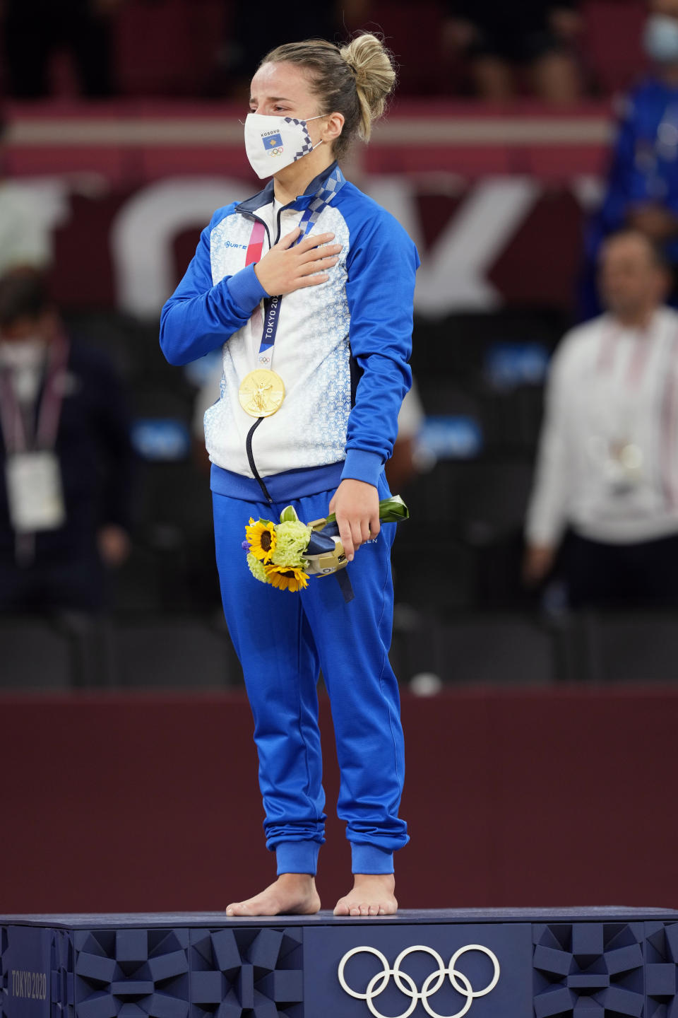 Gold medalist Distria Krasniqi of Kosovo reacts during the medal ceremony for women's -48kg judo at the 2020 Summer Olympics, Saturday, July 24, 2021, in Tokyo, Japan. (AP Photo/Vincent Thian)