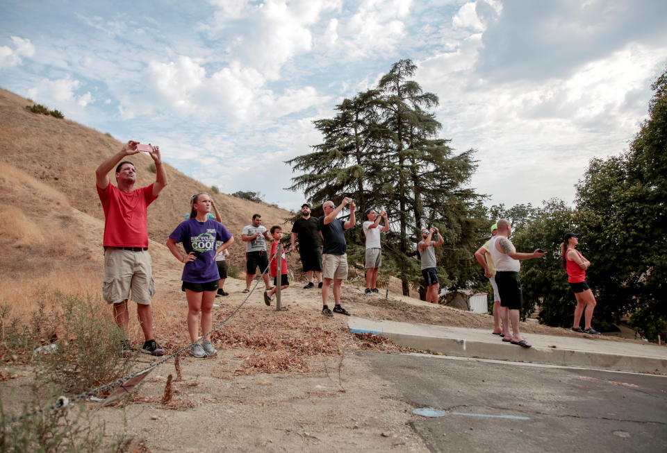 Spectators watch as flames encroach