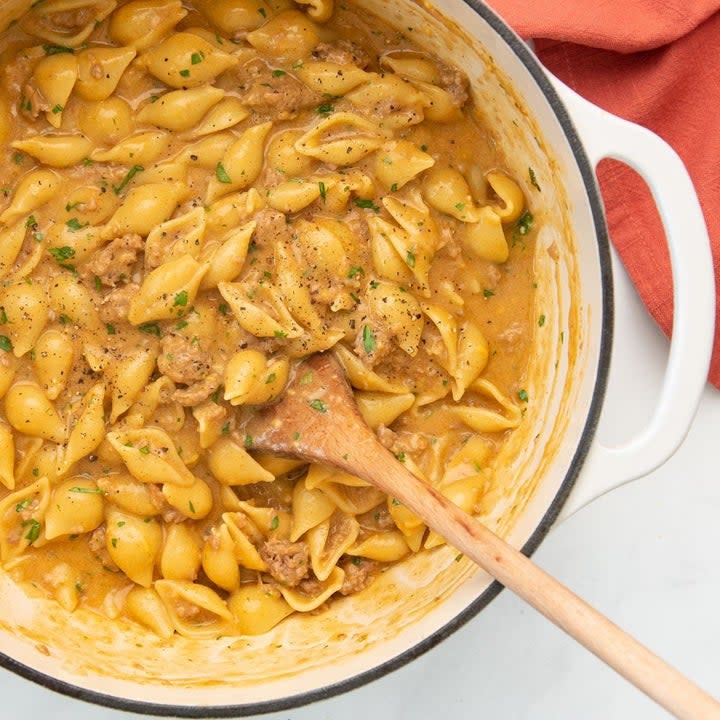 A pan of pasta shells, fake meat, and cheese sauce