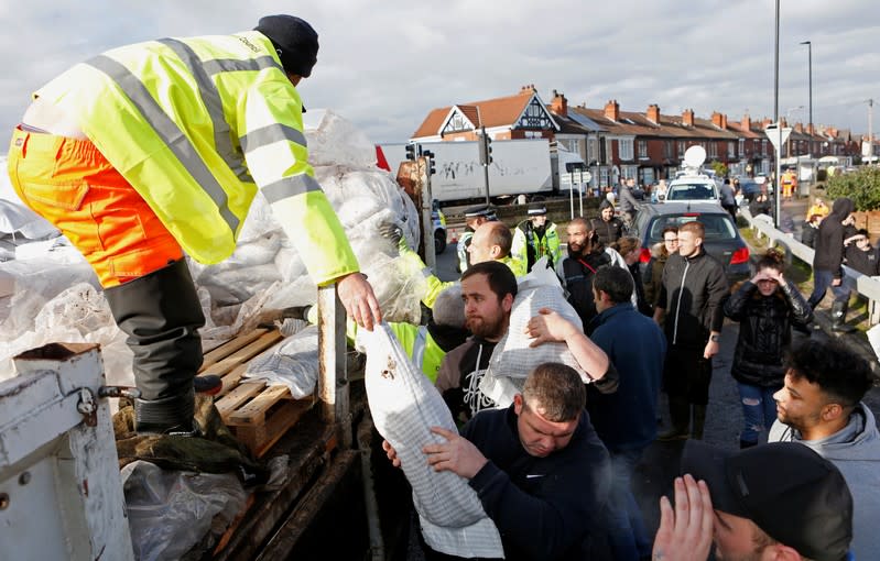 Sandbags are distributed to the residents in a flooded area of Bentley, north of Doncaster