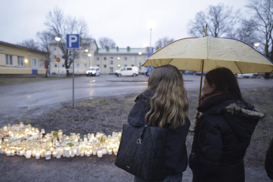 People bring candles and flowers at the Viertola school in Vantaa, Finland, Tuesday April 2, 2024, after a shooting incident. A 12-year-old student opened fire at a secondary school in southern Finland on Tuesday morning, killing one and seriously wounded two other students, police said. The suspect was later arrested. (Roni Rekomaa/Lehtikuva via AP)