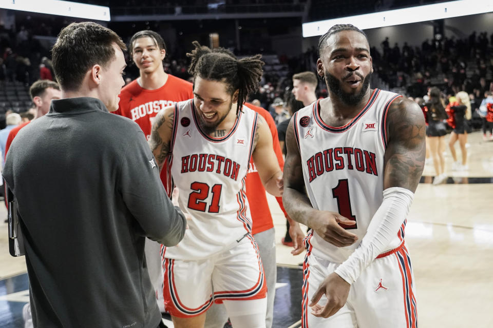 Houston guards Jamal Shead, right, and Emanuel Sharp, center, react as they walk to the locker room after an NCAA basketball game against Cincinnati, Saturday, Feb. 10, 2024, in Cincinnati. (AP Photo/Joshua A. Bickel)