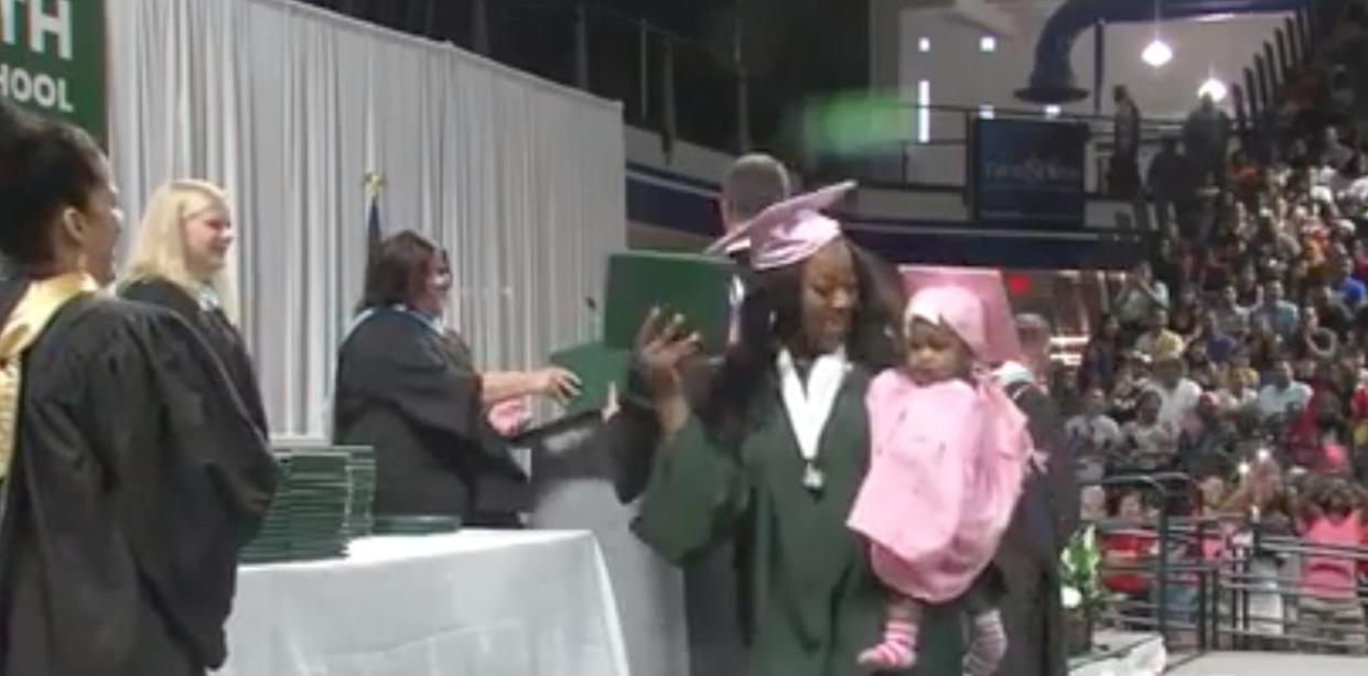 Two teen mothers happily accepted their high school diplomas in Iowa to set examples for their young daughters. (Photo: KCCI)
