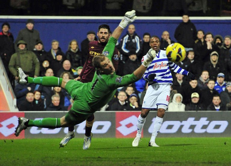 Queens Park Rangers' French striker Loic Remy (R) watches his shot go wide of Manchester City's English goalkeeper Joe Hart (L) during the English Premier League football match between Queens Park Rangers and Manchester City at Loftus Road in London, England on January 29, 2013. The match ended in a 0-0 draw