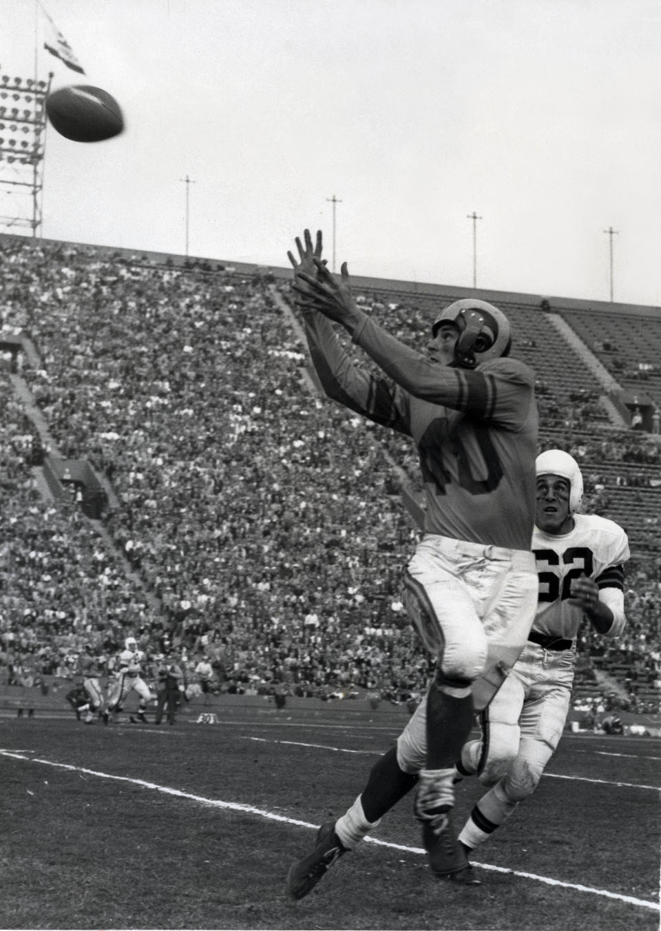 Los Angeles Rams receiver Elroy Hirsch (40) catches a pass in front of Cleveland Browns defensive back Cliff Lewis (62) at the Los Angeles Memorial Coliseum in the 1951 NFL Championship Game. The Rams defeated the Browns 24-17. Darryl Norenberg-USA TODAY Sports