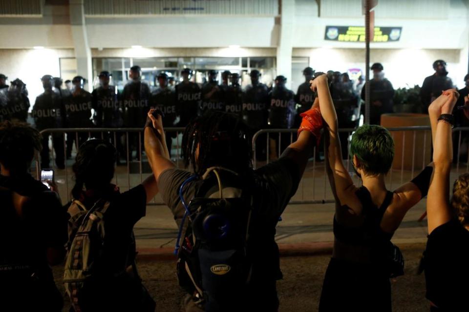 Protesters demonstrate outside of Phoenix police headquarters against the death of George Floyd, killed in Minneapolis, and Dion Johnson, killed in Arizona.