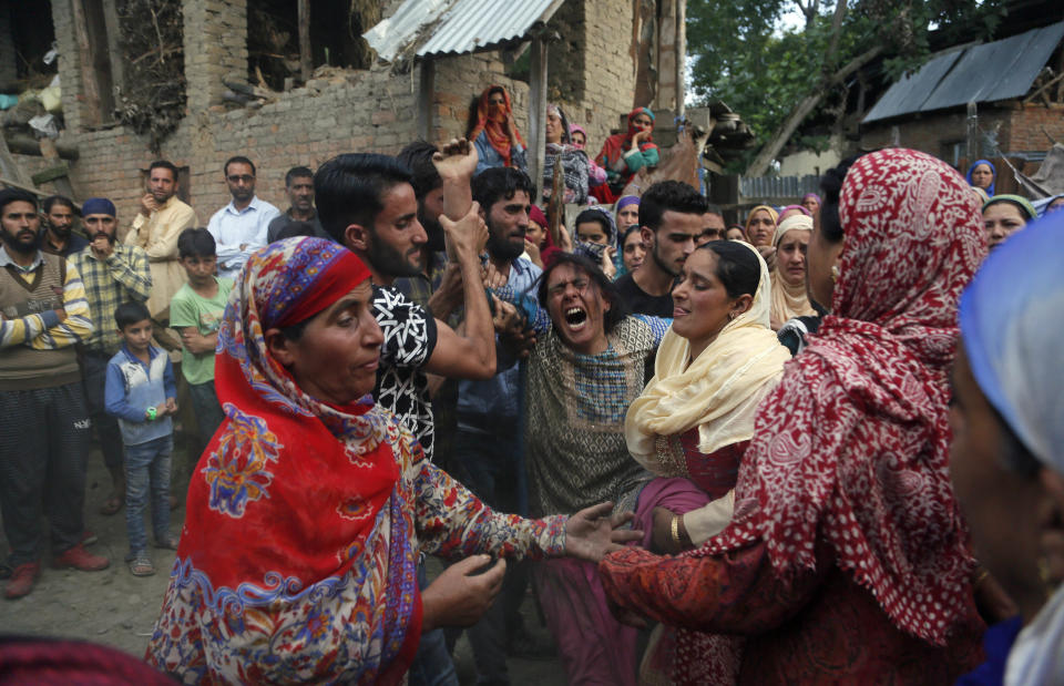 In this Aug. 29, 2018, file photo, Kashmiri woman cries during the funeral of her son, slain policeman Adil Ahmad, at Zaura village, about 62 kilometers (38 miles) south of Srinagar, Indian controlled Kashmir. Rebels fighting against Indian rule ambushed a group of police officers and killed four of them, including Ahmad, on Wednesday in the disputed Himalayan region of Kashmir, police said. (AP Photo/Mukhtar Khan, File)