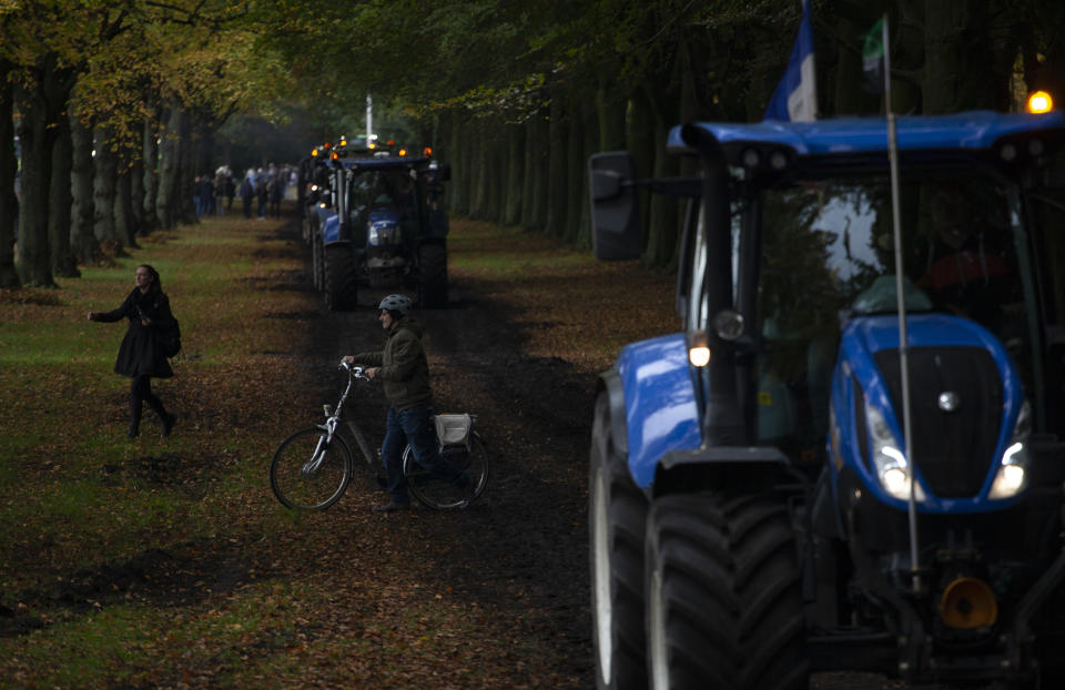 Protesting farmers arrive in The Hague, Netherlands, Wednesday, Oct. 16, 2019. Thousands of Dutch farmers protest over the Netherlands efforts to drastically reduce emissions of greenhouse gases. Among the farmers' demands are that the government does not further reduce the number of animals they can keep. (AP Photo/Peter Dejong)