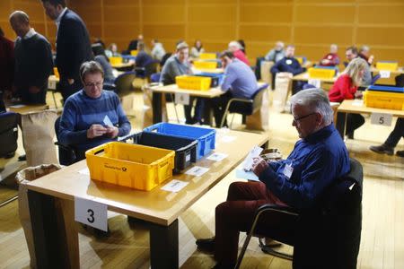 German Social Democratic Party (SPD) members count ballot papers of the voting for a possible coalition between the Social Democratic Party (SPD) and the Christian Democratic Union (CDU) in the SPD headquarters in Berlin, Germany March 3, 2018. REUTERS/Hannibal Hanschke