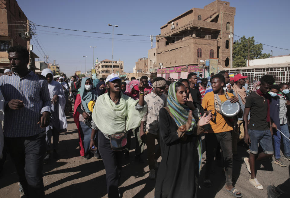 Thousands of protesters take to the streets to renew their demand for a civilian government in the Sudanese capital Khartoum, Thursday, Nov. 25, 2021. The rallies came just days after the military signed a power-sharing deal with the prime minister, after releasing him from house arrest and reinstating him as head of government. The deal came almost a month after the generals orchestrated a coup. Sudan’s key pro-democracy groups and political parties have dismissed the deal as falling short of their demands for a fully civilian rule. (AP Photo/Marwan Ali)