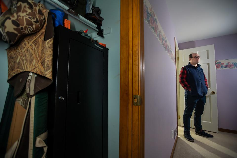 State Sen. John Cherry, D-Flint, stands near his gun safe at his home in Flint where he keeps his five guns used for hunting locked from his young daughter. Cherry voted for legislation signed into law by Gov. Gretchen Whitmer requiring the safe storage of firearms aimed at keeping guns out of the hands of children.