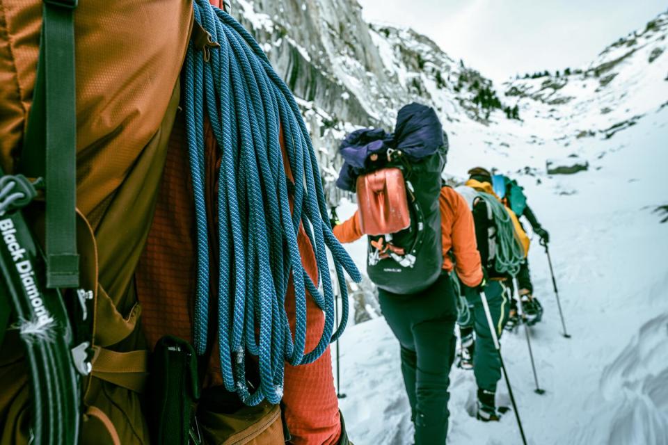 A line of people walking in the snow with poles at Lee Vining in Mammoth