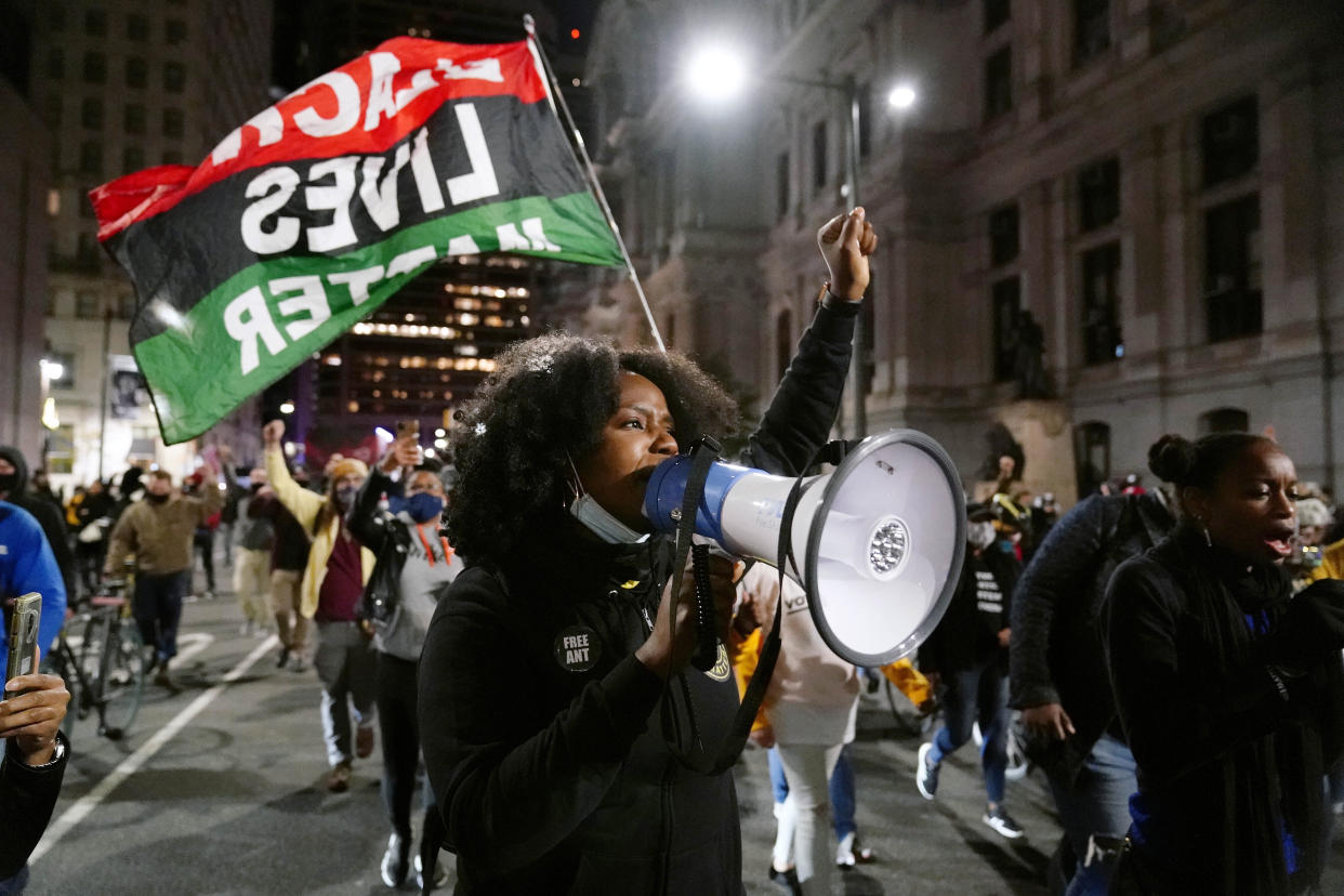 A Black Lives Matter protester marches in Philadelphia last November to urge that all votes be counted. (Matt Slocum/AP)