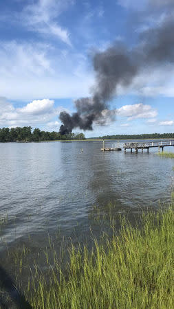 Smoke rises at the site of a F-35 fighter jet crash in Beaufort, South Carolina, U.S., September 28, 2018 in this still image obtained from social media. KENSLEY MINCEY CROSBY/via REUTERS