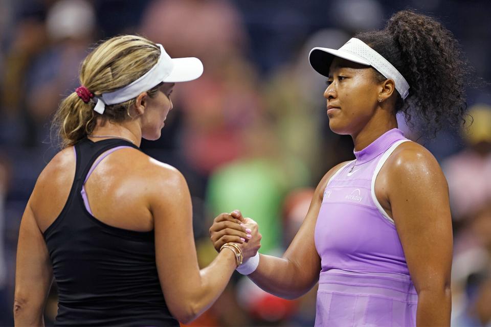 Danielle Collins (L) of the United States shakes hands with Naomi Osaka (R) of Japan after defeating her in their Women's Singles First Round match on Day Two of the 2022 US Open at USTA Billie Jean King National Tennis Center on August 30, 2022 in the Flushing neighborhood of the Queens borough of New York City.