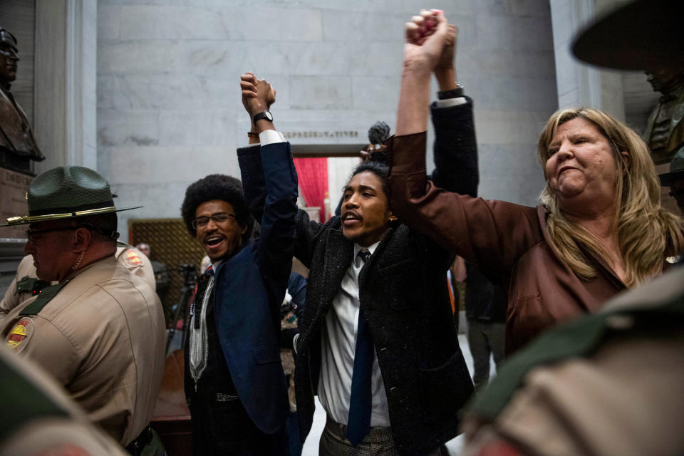 Tennessee Democratic state Reps. Justin Pearson, Justin Jones and Gloria Johnson hold their hands up as they exit the House chamber doors in Nashville on April 3, 2023. (Nicole Hester / The Tennessean via USA TODAY Network)