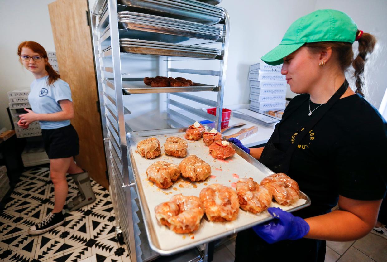 In this file photo, a Parlor Doughnuts employee stocks fresh doughnuts at a Missouri store in 2023.