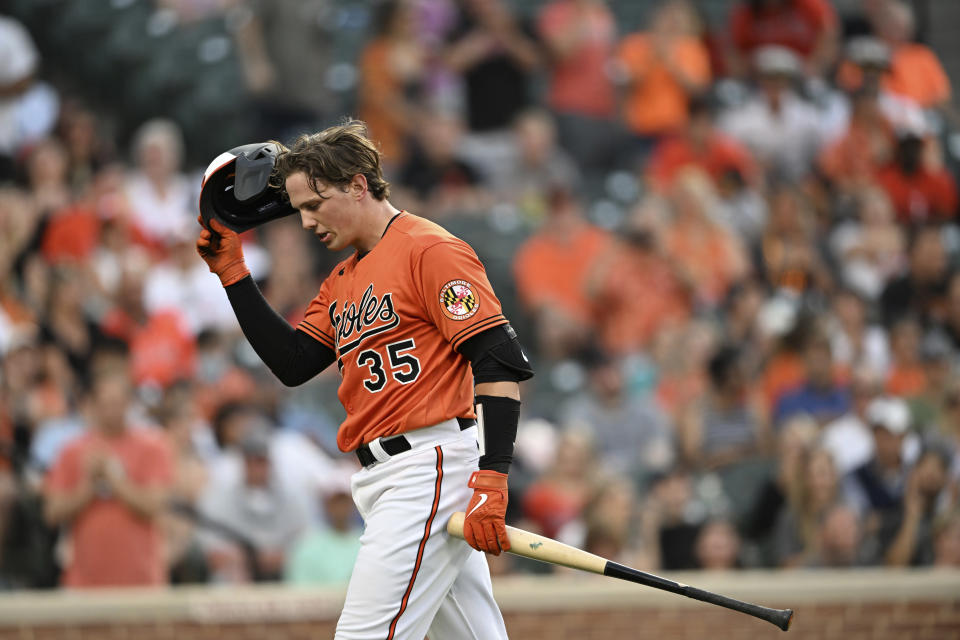 Baltimore Orioles' Adley Rutschman walks to the dugout after striking out against the Tampa Bay Rays during the second inning of a baseball game Saturday, May 21, 2022, in Baltimore. (AP Photo/Gail Burton)