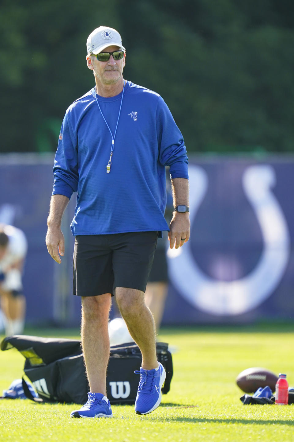 Indianapolis Colts head coach Frank Reich walks on the field before the start of practice at the NFL team's football training camp in Westfield, Ind., Monday, Aug. 2, 2021. Reich returned to practice following his quarantine period and two negative tests after a positive test for COVID-19. (AP Photo/Michael Conroy)