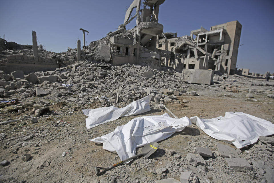 Bodies covered in plastic lie on the ground amid the rubble of a Houthi detention center destroyed by Saudi-led airstrikes, that killed at least 60 people and wounding several dozen according to officials and the rebels' health ministry, in Dhamar province, southwestern Yemen, Sunday, Sept. 1, 2019. The officials said the airstrikes took place Sunday and targeted a college in the city of Dhamar, which the Houthi rebels use as a detention center. The Saudi-led coalition said it had hit a Houthi military facility used as storages for drones and missiles in Dhamar. (AP Photo/Hani Mohammed)
