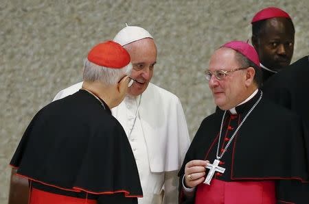 Pope Francis talks with Cardinal Lorenzo Baldisseri (L) and Bishop Fabio Fabene (2nd R) during a special audience to mark the 50th anniversary of Synod of Bishops in Paul VI hall at the Vatican October 17, 2015. REUTERS/Tony Gentile -