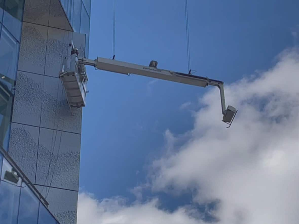 The window cleaners were stuck on their platform for about an hour. (Denis Dossman/CBC - image credit)