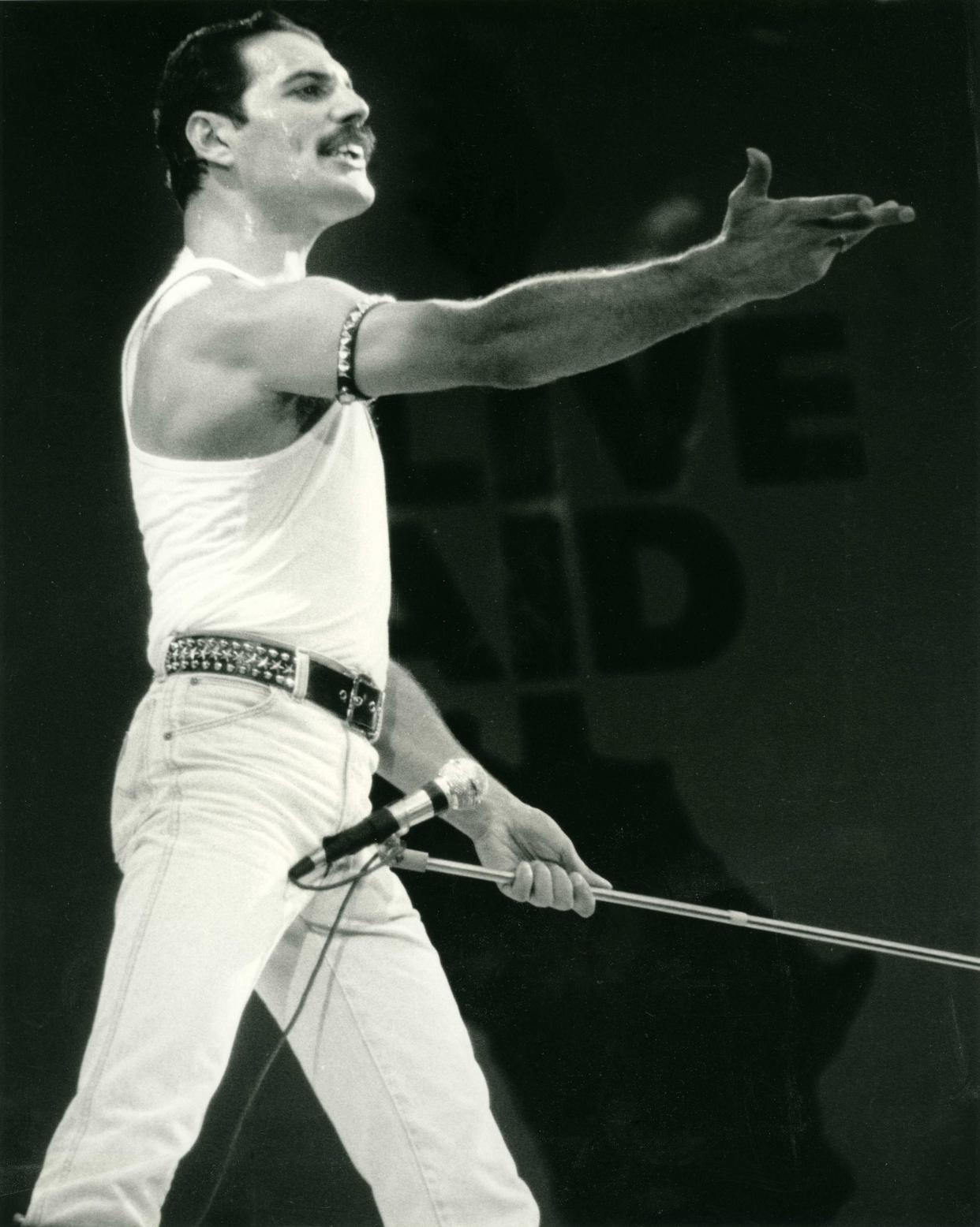 Freddie Mercury with Queen on stage at Live Aid on 13 July 1985 at Wembley Stadium, London.