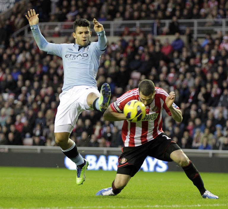 Sunderland's Carlos Cuellar (R) fights for the ball with Manchester City's Sergio Aguero during their English Premier League match at The Stadium of Light in Sunderland, north-east England, on December 26, 2012. Man City travel to Norwich next, while Sunderland host Tottenham, on Saturday