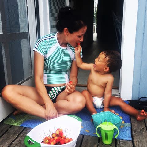 <p>Lucy Liu Instagram</p> Lucy Liu with her son Rockwell Lloyd Liu eating strawberries.