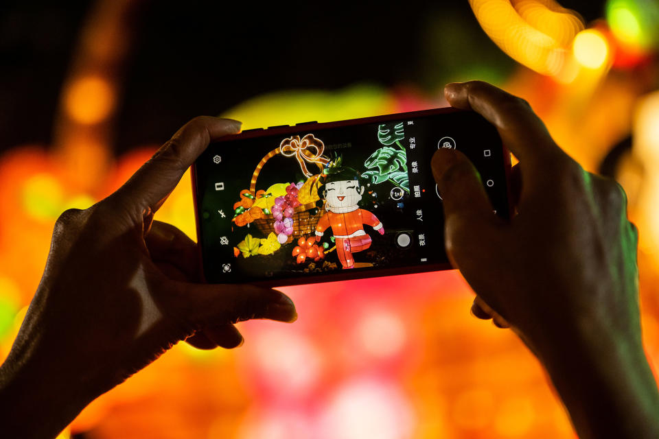 A photo of decorations is seen on someone's phone during Lantern Festival celebrations in in Guangzhou Cultural Park in China, Feb. 5, 2023.