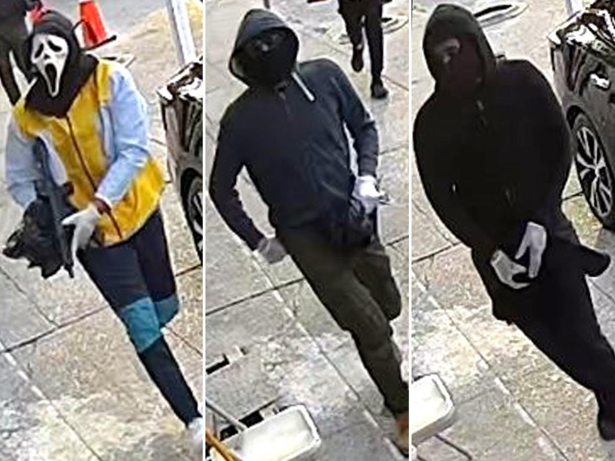Surveillance video shows gunman in Ghostface mask and two others rob smoke shop in Queens, police said.