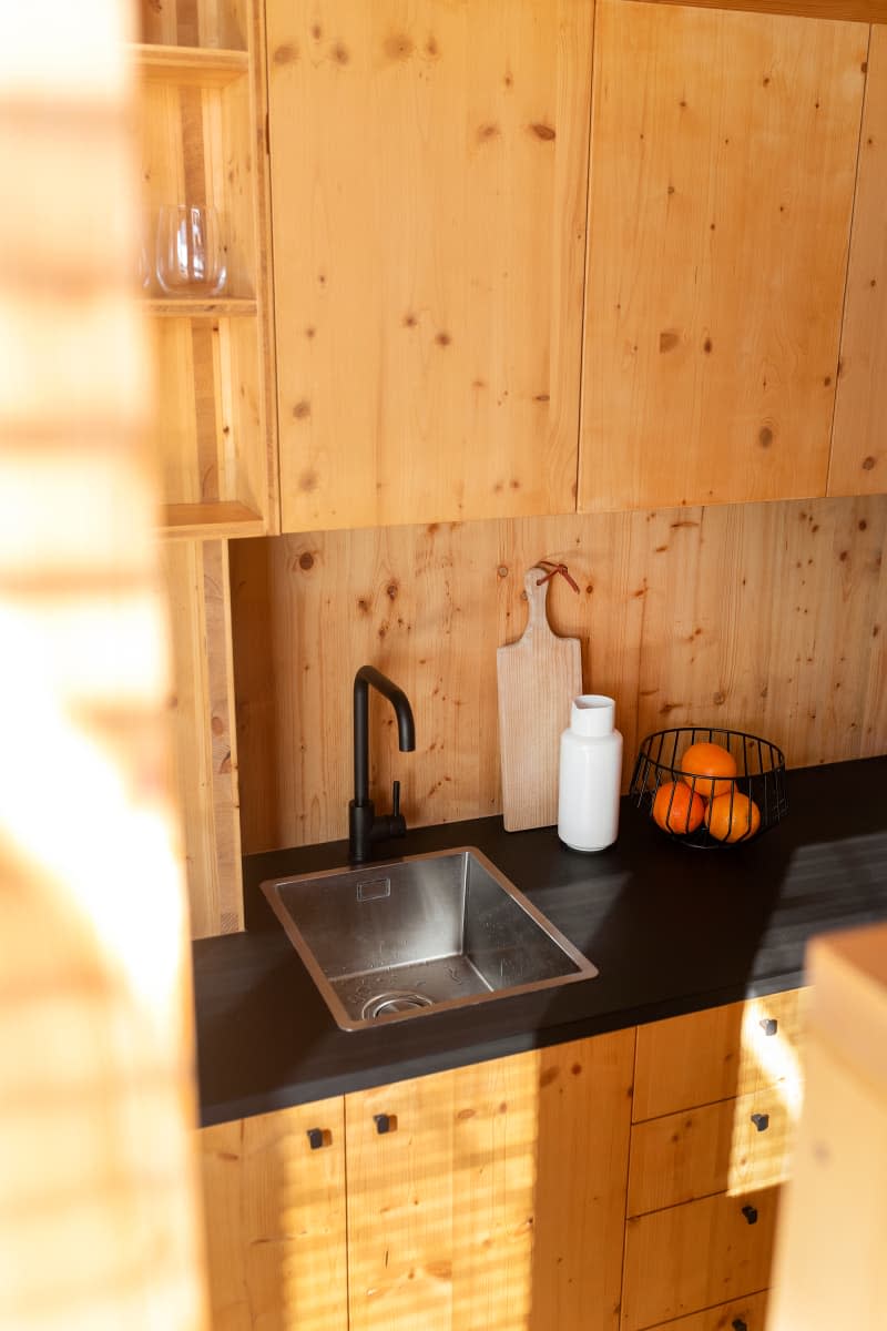 all wood kitchen with black countertop