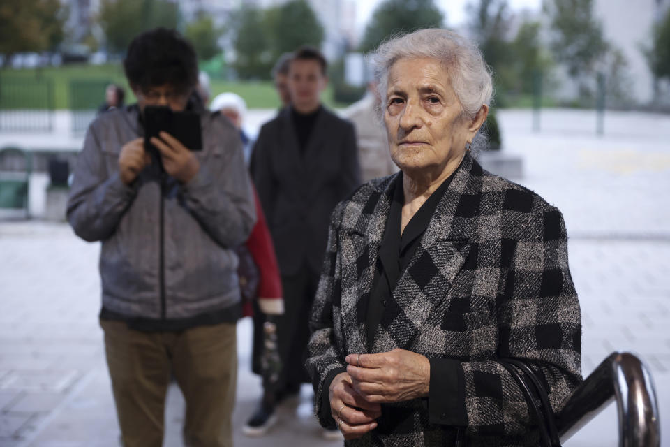 Bosnian woman waits in line to cast her vote at a poling station in Sarajevo, Bosnia, Sunday, Oct. 2, 2022. Polls opened Sunday in Bosnia for a general election that is unlikely to bring any structural change despite palpable disappointment in the small, ethnically divided Balkan country with the long-established cast of sectarian political leaders. (AP Photo/Armin Durgut)