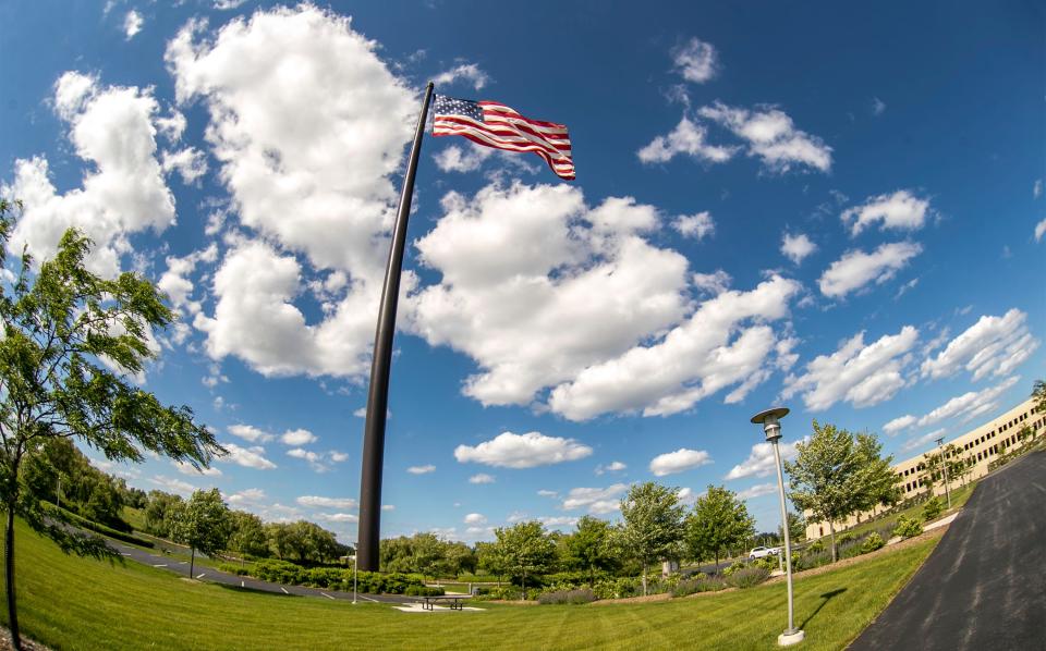 The American flag flies in the wind at Acuity Insurance headquarters in Sheboygan, Wis.