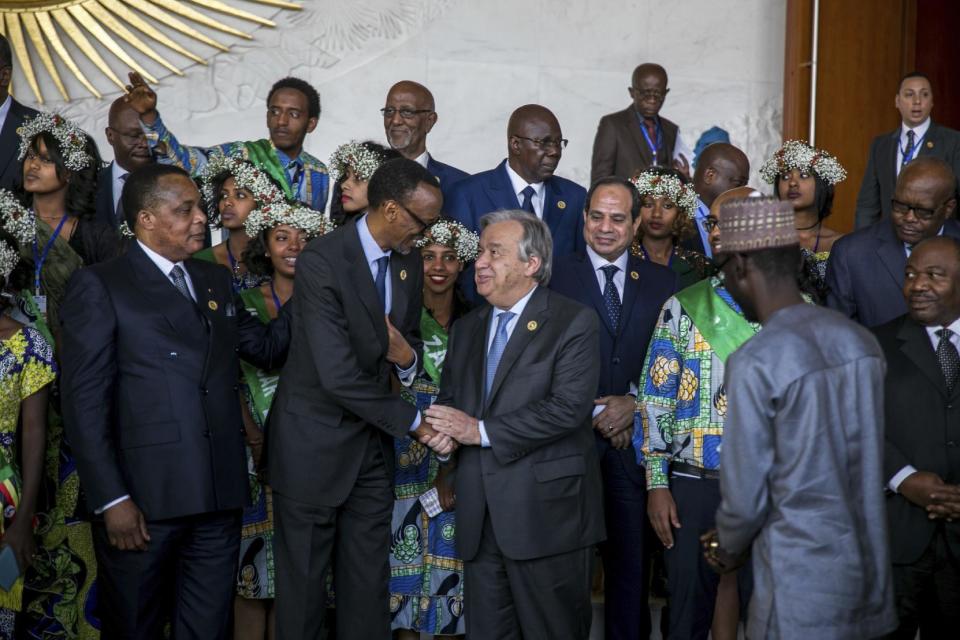 United Nations Secretary-General Antonio Guterres, centre right, shakes the hand of Rwandan President Paul Kagame during the 28th Ordinary Session of the Assembly of the African Union, in Addis Ababa, Ethiopia, Monday, Jan. 30, 2017. The U.N. Secretary General Antonio Guterres on Monday commended African countries for opening their borders to refugees and people fleeing violence.(AP Photo/Mulugeta Ayene )