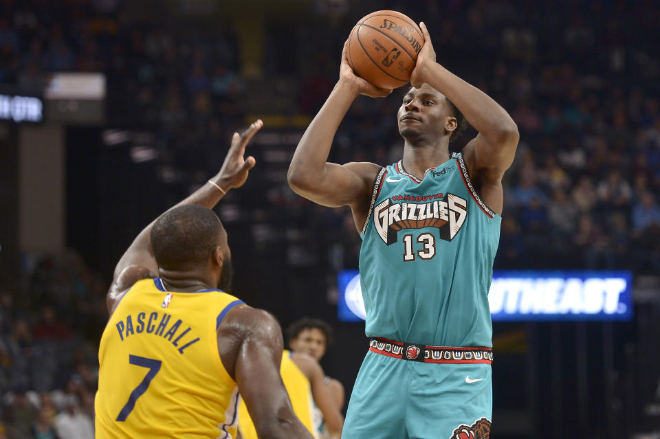 Memphis Grizzlies forward Jaren Jackson Jr. (13) shoots against Golden State Warriors forward Eric Paschall (7) in the second half of an NBA basketball game Sunday, Jan. 12, 2020, in Memphis, Tenn. (AP Photo/Brandon Dill)