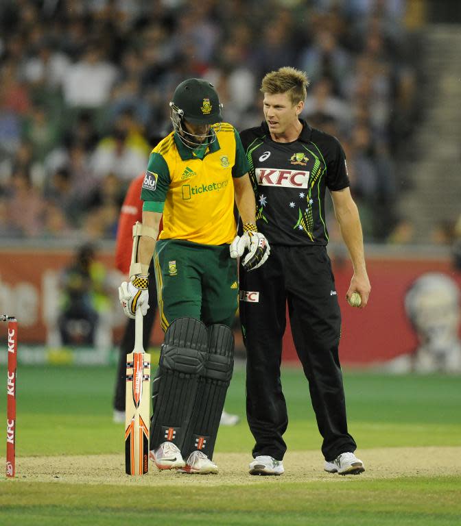 Wayne Parnell of South Africa (L) and James Faulkner of Australia exchange words during the T20 cricket match played at the MCG in Melbourne on November 7, 2014