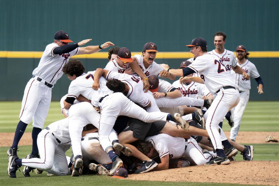 Virginia players celebrate after an NCAA college baseball tournament super regional game against Dallas Baptist, Monday, June 14, 2021, in Columbia, S.C. (AP Photo/Sean Rayford)