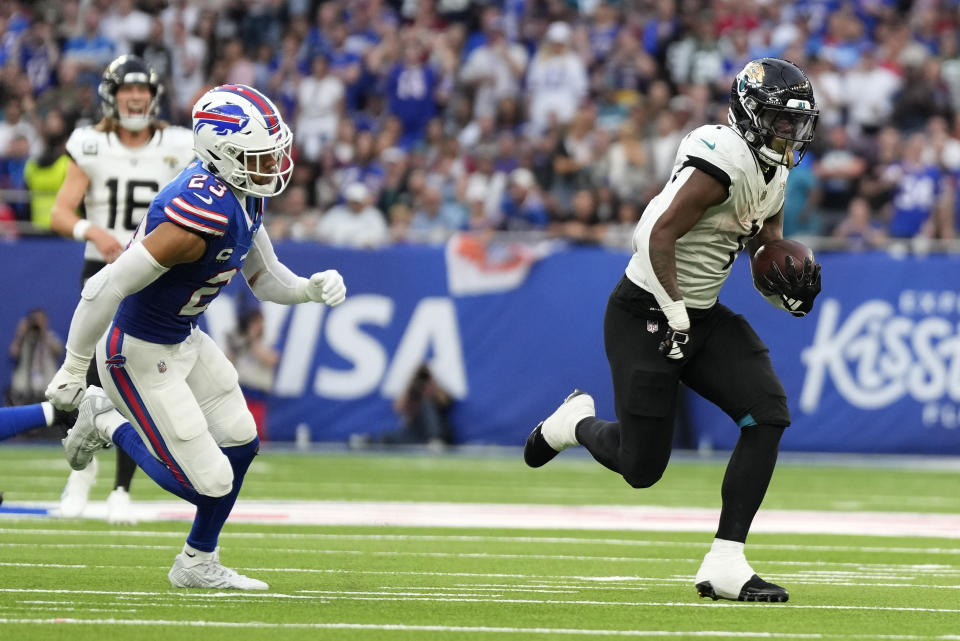 Jacksonville Jaguars running back Travis Etienne Jr. (1) runs in to score a touchdown during an NFL football game between Jacksonville Jaguars and Buffalo Bills at the Tottenham Hotspur stadium in London, Sunday, Oct. 8, 2023. (AP Photo/Alastair Grant)