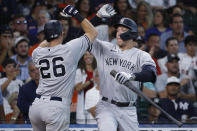 New York Yankees' DJ LeMahieu (26) celebrates with Aaron Judge after hitting a solo home run during the fifth inning in the first game of a baseball doubleheader against the Houston Astros Thursday, July 21, 2022, in Houston. (AP Photo/Kevin M. Cox)