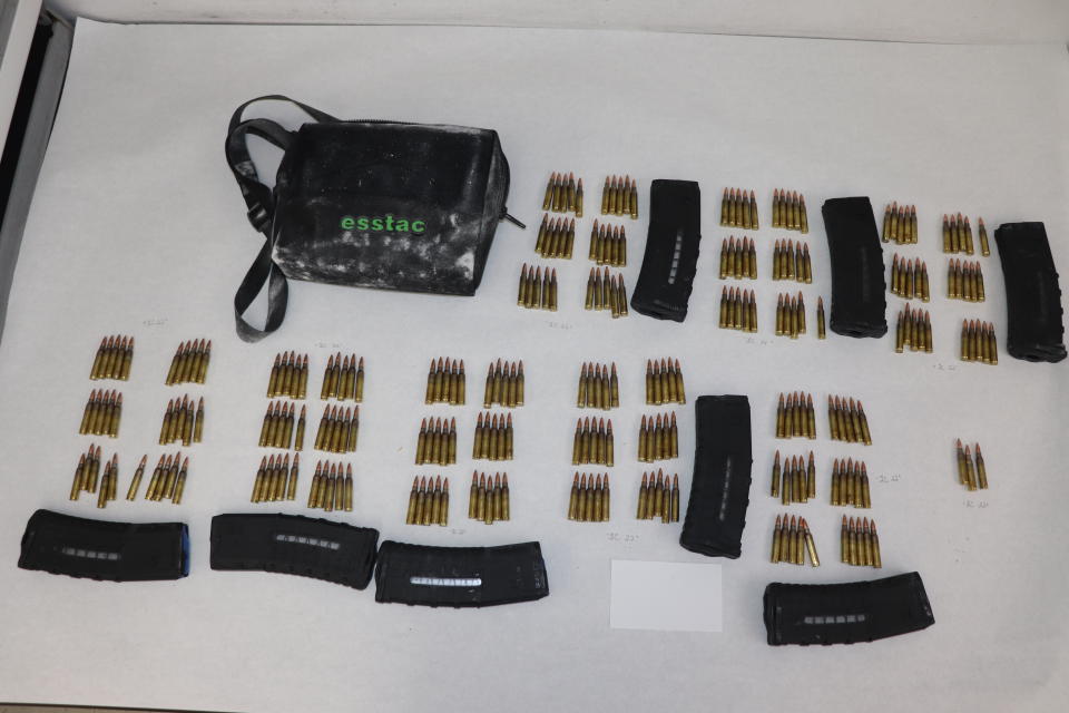 This image provided by the St. Louis Metropolitan Police Department shows ammunition and magazines used by a 19-year-old gunman who killed a teacher and a 15-year-old girl at a St. Louis high school on Monday, Oct. 24, 2022. The gunman was armed with an AR-15-style rifle and what appeared to be more than 600 rounds of ammunition, Police Commissioner Michael Sack said Tuesday, Oct. 25, 2022. (St. Louis Metropolitan Police Department via AP)