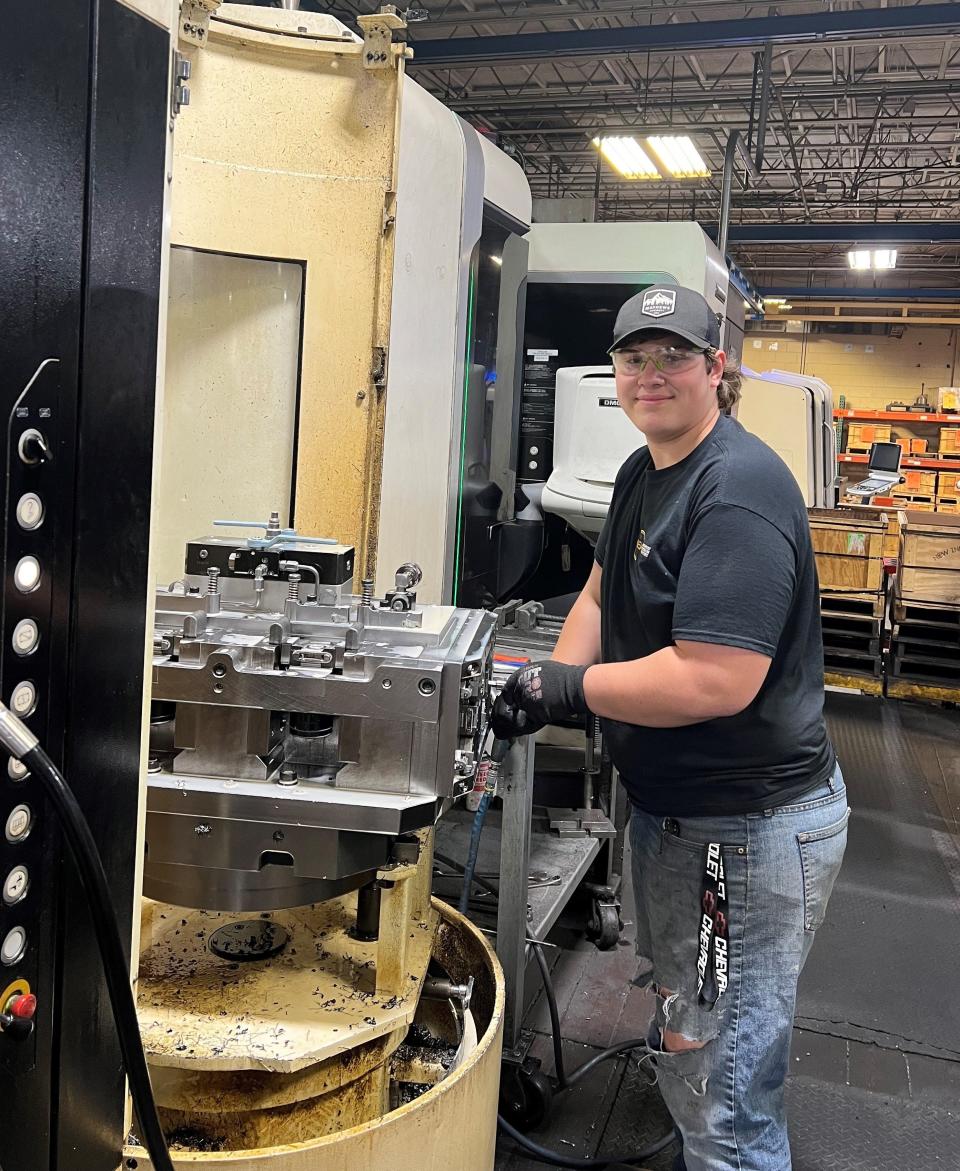 Bradan Wessel, a senior at Southern Door High School, works on a CNC machine at N.E.W. Industries in Sturgeon Bay. Wessel is a student in the countywide Door County Machining Program for high school students and has worked with N.E.W. since July 2022.